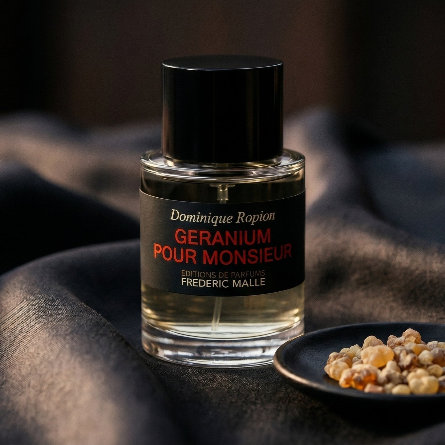 Frederic Malle Geranium Pour Monsieur EDP on onyx linen with dried rose petals and resin drops intermixed