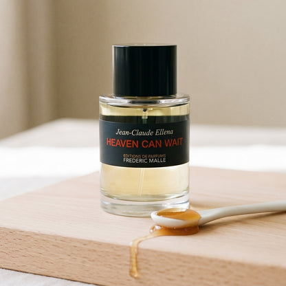 Frederic Malle Heaven Can Wait EDP on birch surface with a glass jar of demerara sugar