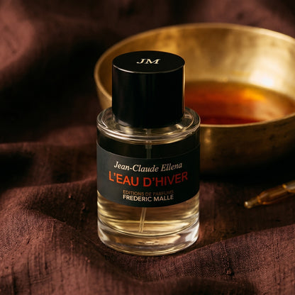 Frederic Malle L'Eau D'Hiver EDT on deep caramel velvet with a small copper jar of resin balm