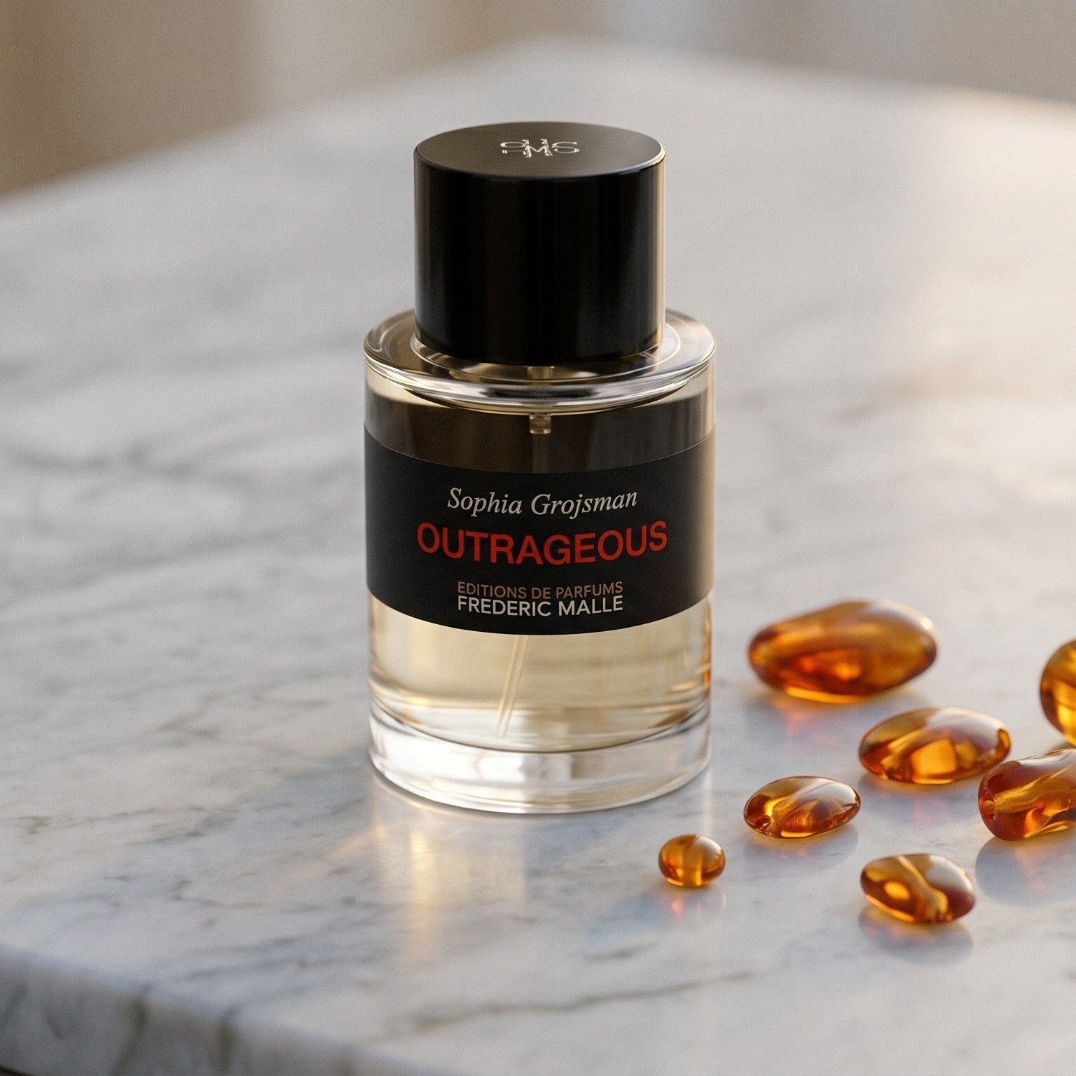 Frederic Malle Outrageous EDP on warm ivory travertine with labdanum chunks clustered by the base