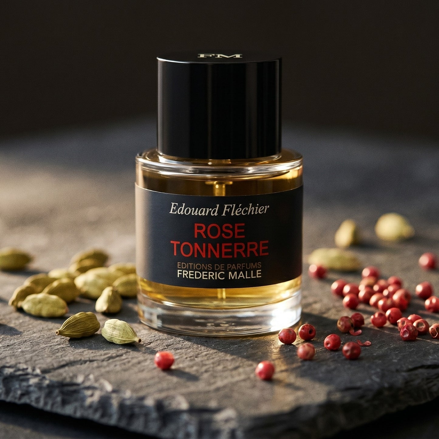 Frederic Malle Rose Tonnere EDP on blackened stone with a small copper tin of cumin and coriander