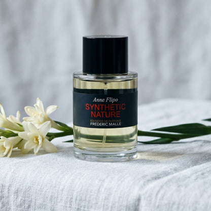 Frederic Malle Synthetic Nature EDP on pale muslin with a spray of osmanthus and jasmine petals