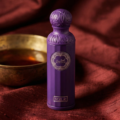 Gissah Voila on burnt-orange raw silk with a brass vial of frankincense oil