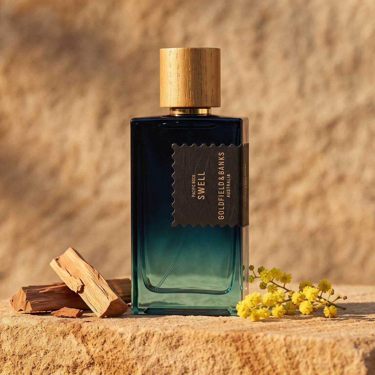Goldfield & Banks Pacific Rock Swell Extrait de Parfum on warm sandstone with sandalwood chips and mimosa