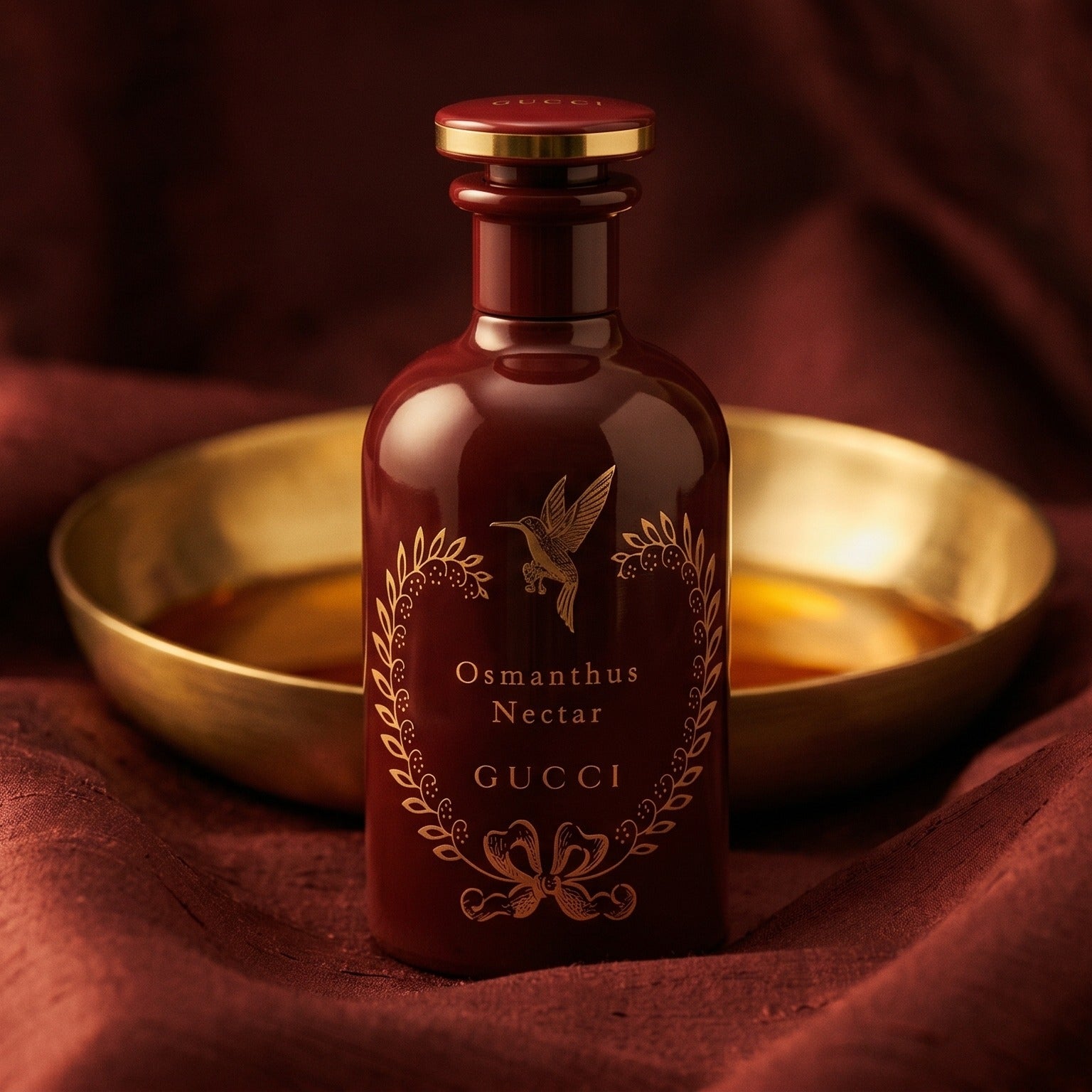 Gucci The Alchemist Garden Osmanthus Nectar EDP on burnt-orange raw silk with a brass vial of frankincense oil
