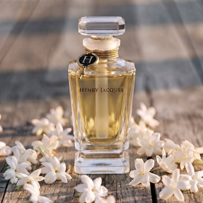 Henry Jacques Still Extrait - Abu Dhabi Exclusive on a weathered teak wood board with scattered jasmine flowers