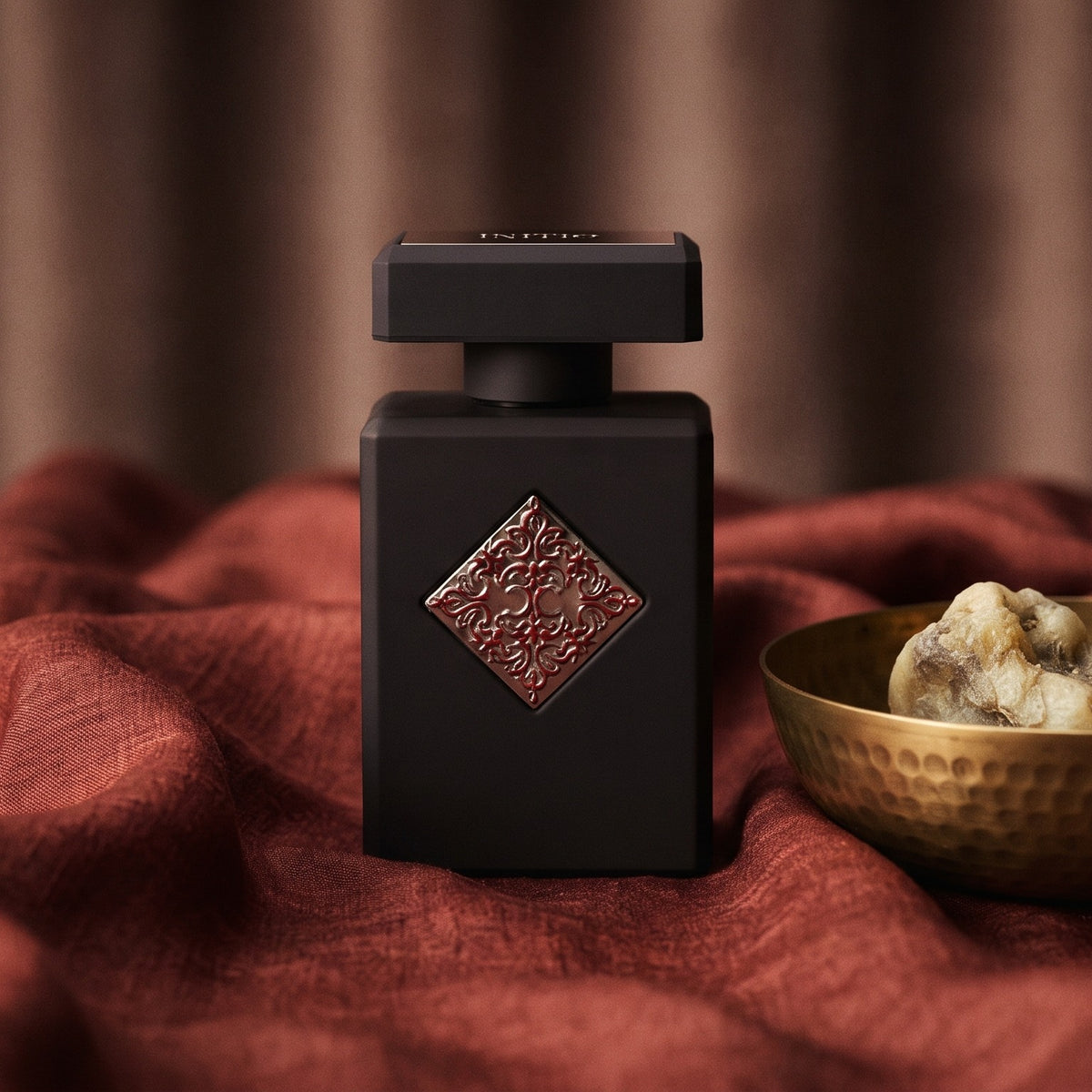 Initio Blessed Baraka EDP on raw silk of oxblood color with a brass bowl with ambergris tincture