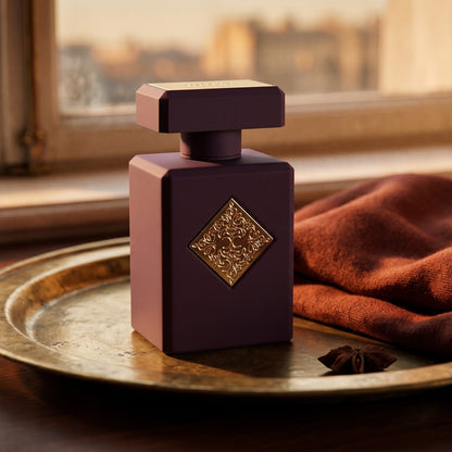 Initio Side Effect EDP on aged brass tray with a folded pashmina in rust tone