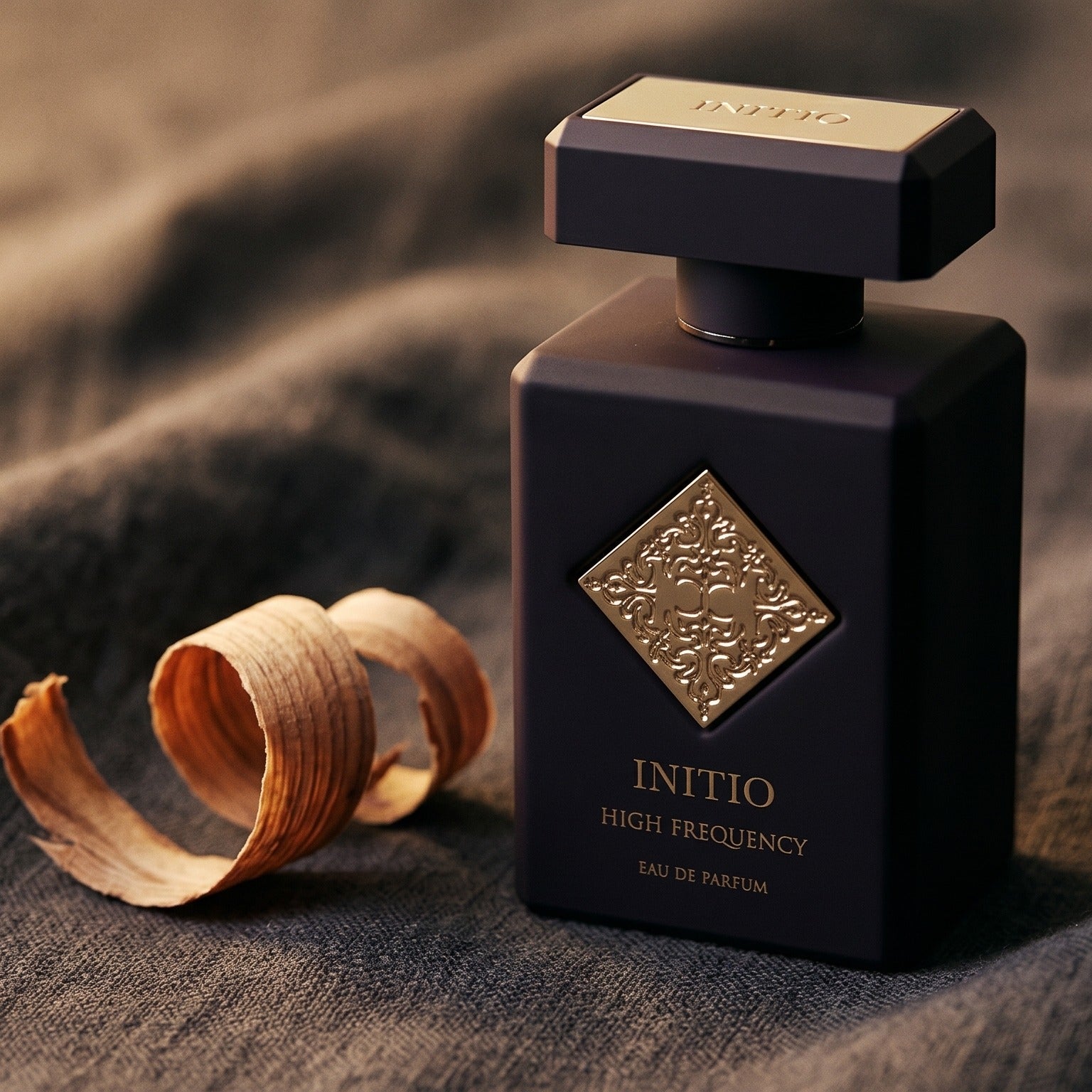 Initio High Frequency EDP on graphite linen with a curl of cypress wood shavings