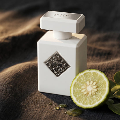 Initio Power Self Extrait de Perfum on charcoal linen with a halved bergamot