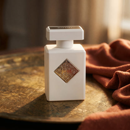 Initio Power Self Extrait de Perfum on weathered brass plate with a wool scarf dyed in paprika red