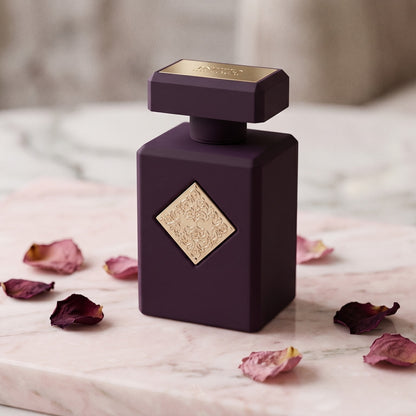 Initio Psychedelic Love EDP on champagne-pink stone with tea-rose petals in soft clusters