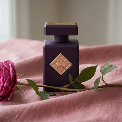 Initio Psychedelic Love EDP on raw silk in dusty pink with a single damask rose stem resting aslant