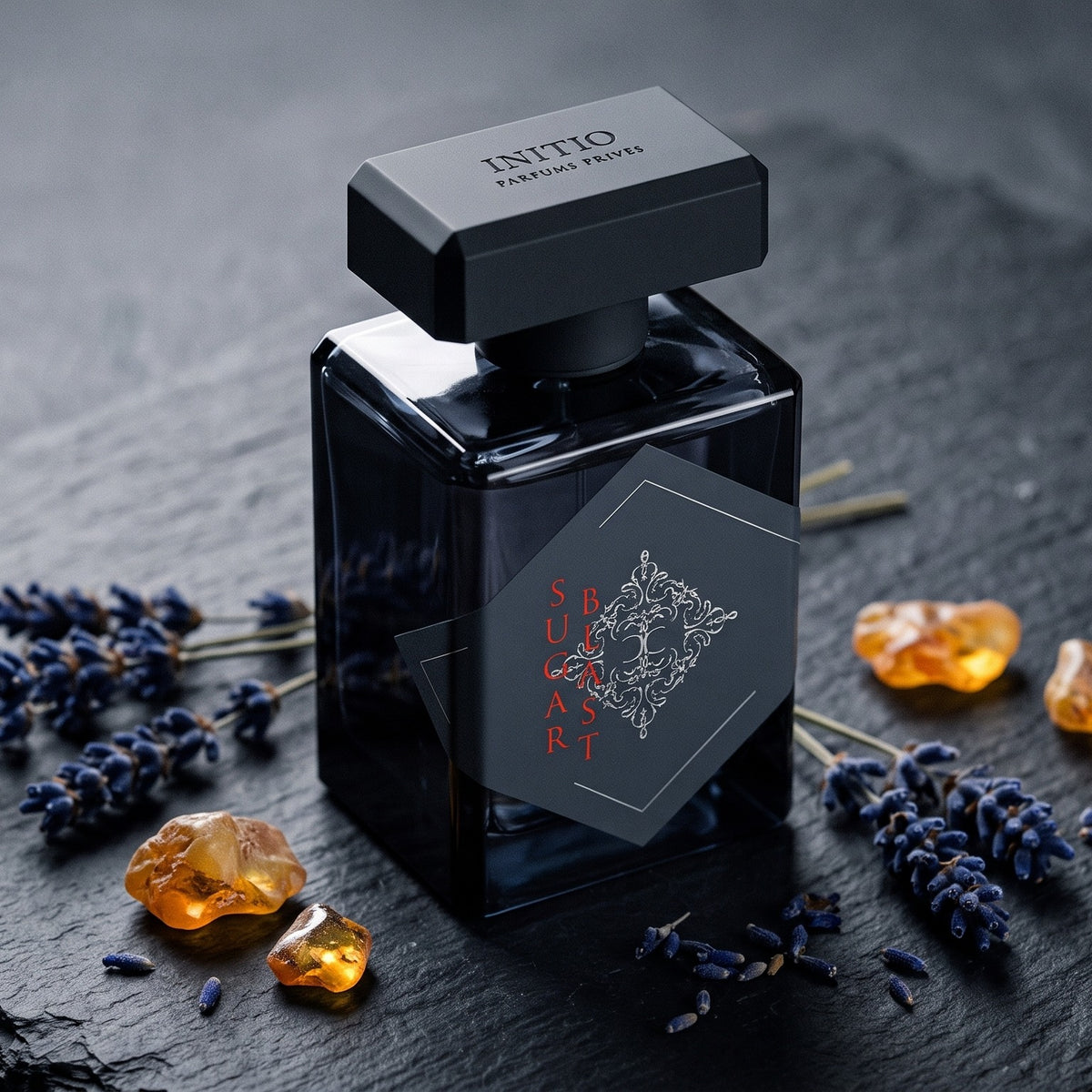 Initio Sugar Blast EDP on dark slate with dried lavender and amber resin