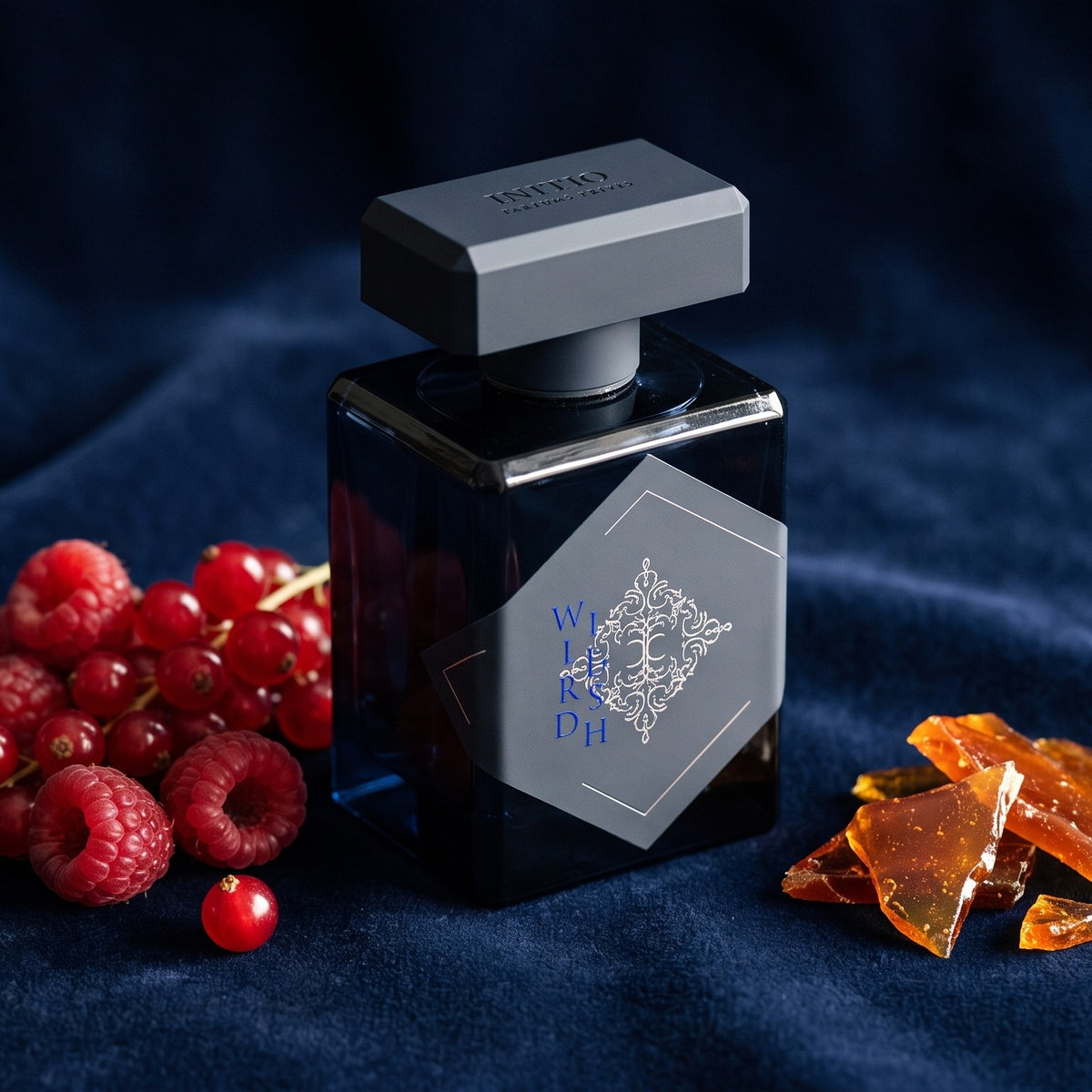 Initio Wild Rush EDP on deep navy velvet with red berries and caramel shards