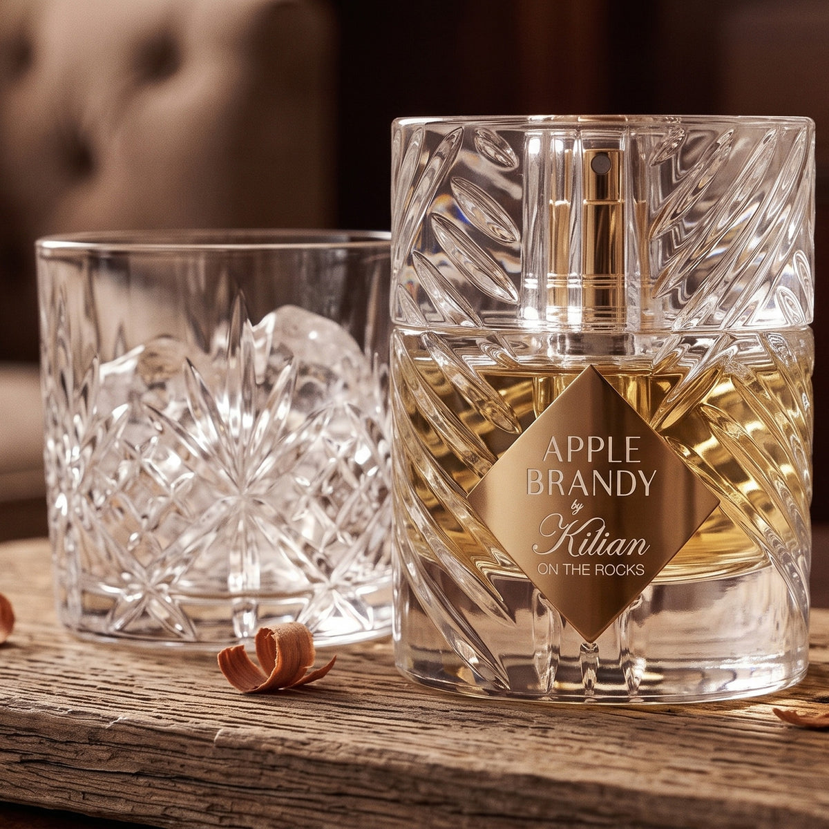 Kilian Apple Brandy on the Rocks on cedar board with a few cedar shavings beside a cut-crystal tumbler with ice