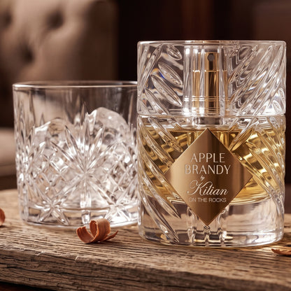 Kilian Apple Brandy on the Rocks on cedar board with a few cedar shavings beside a cut-crystal tumbler with ice