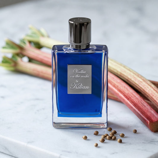 Kilian Vodka On The Rocks EDP on frosted white marble with rhubarb stalks and a few coriander seeds