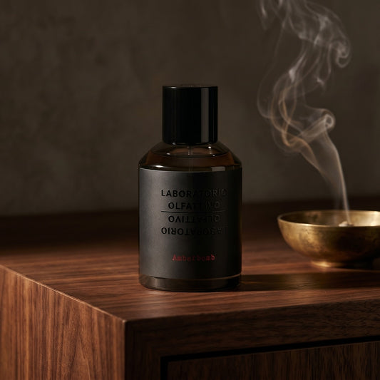 Laboratorio Olfattivo Amberbomb on charcoal slate with a slender oud chip and drifting incense smoke