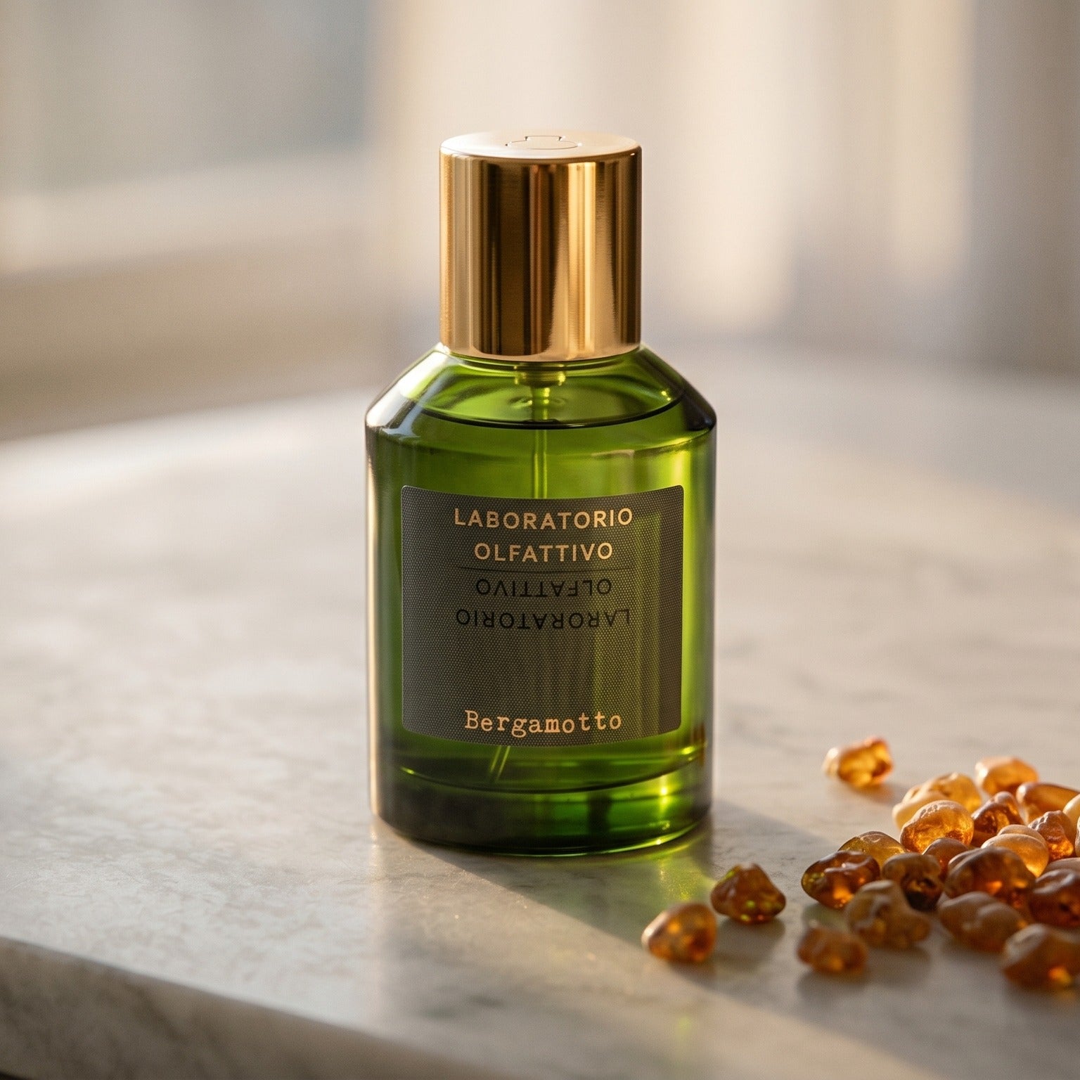 Laboratorio Olfattivo Bergamotto EDP on polished limestone with benzoin resin pebbles arranged loosely