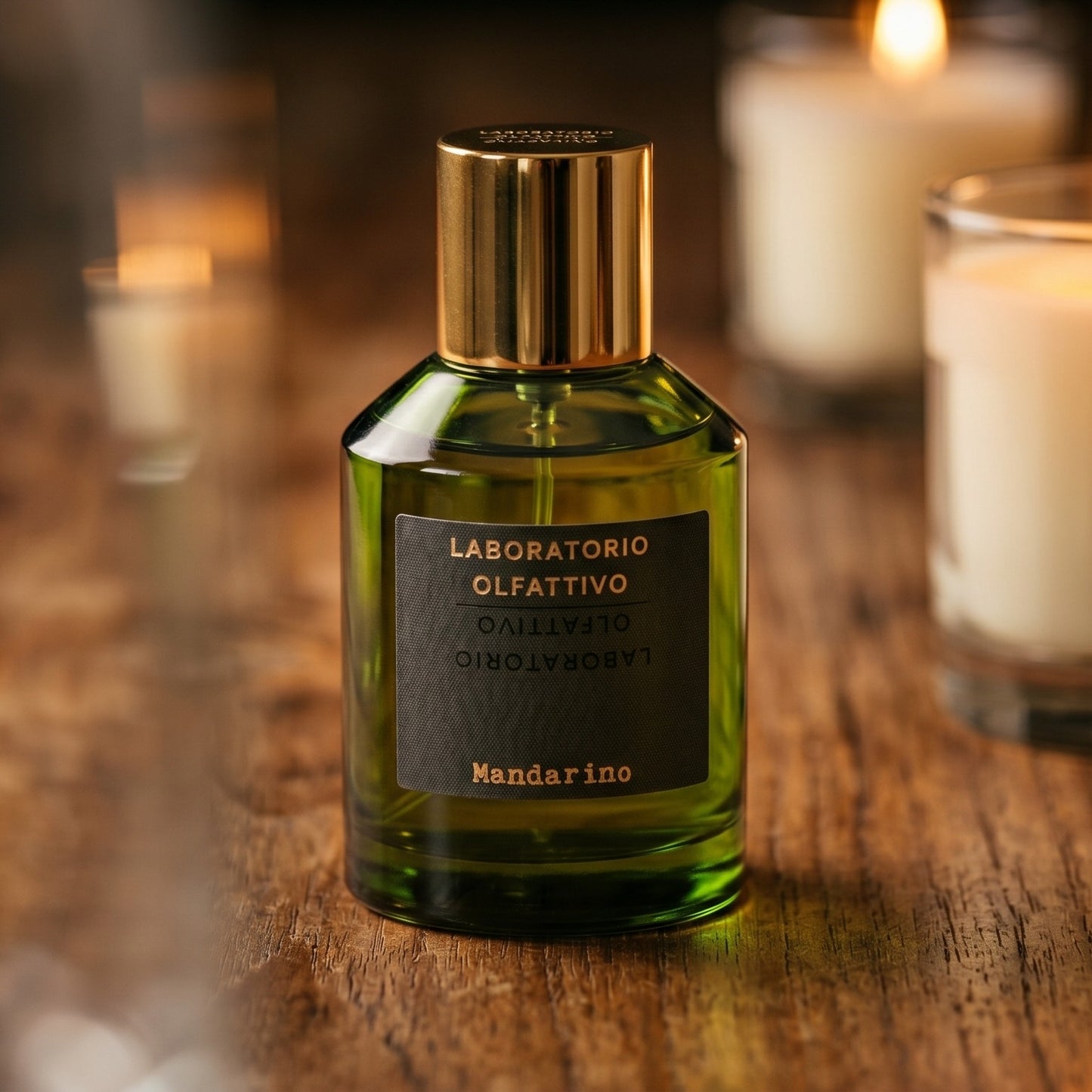 Laboratorio Olfattivo Mandarino on walnut side table with a pair of lit votives beside the bottle