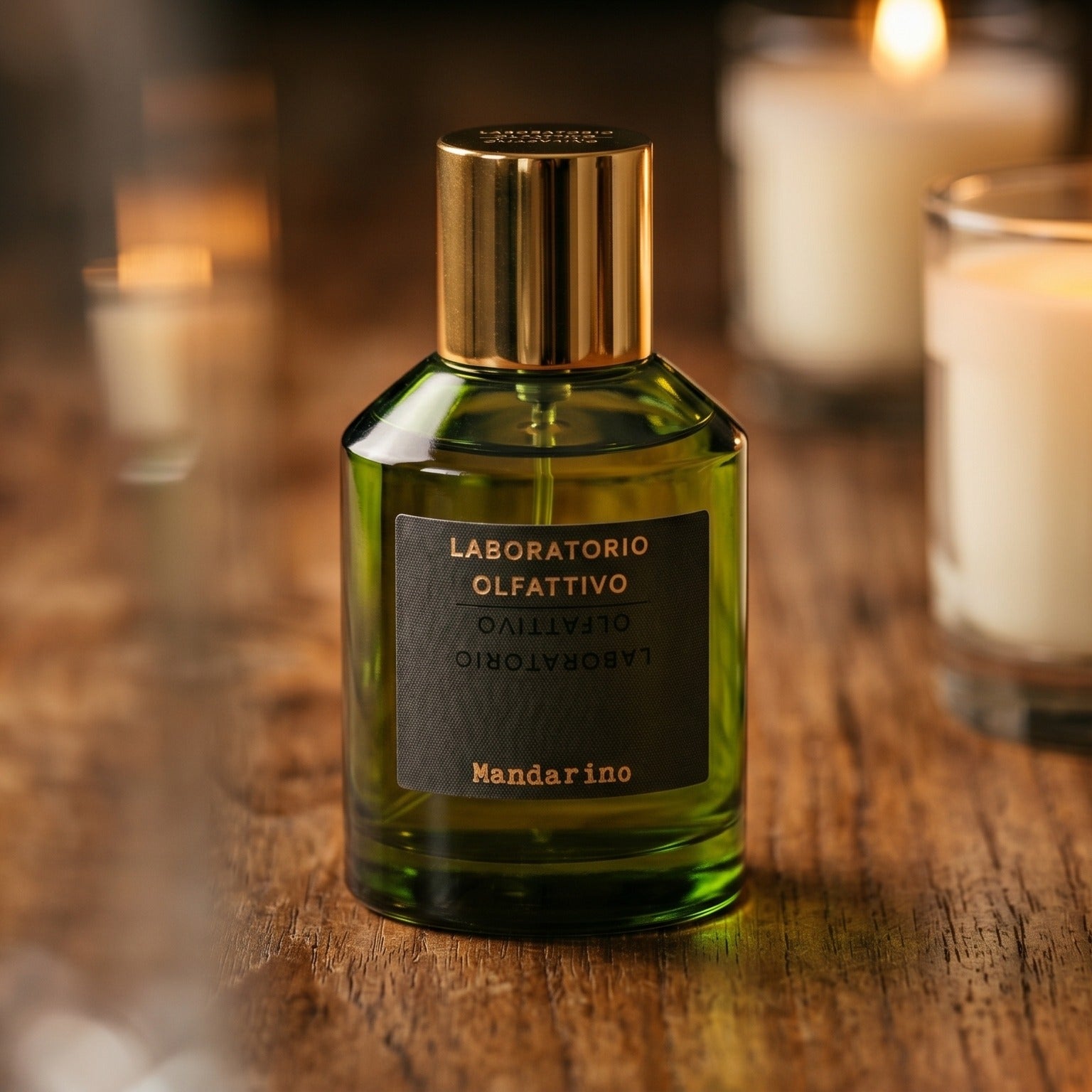 Laboratorio Olfattivo Mandarino on walnut side table with a pair of lit votives beside the bottle