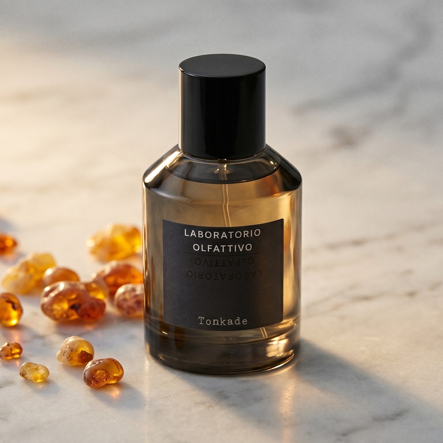 Laboratorio Olfattivo Tonkade on polished limestone with benzoin resin pebbles arranged loosely