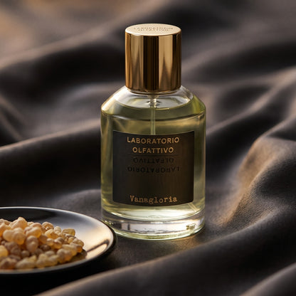 Laboratorio Olfattivo Vanagloria EDP on burnt-orange silk with smoldering agarwood on a stone dish