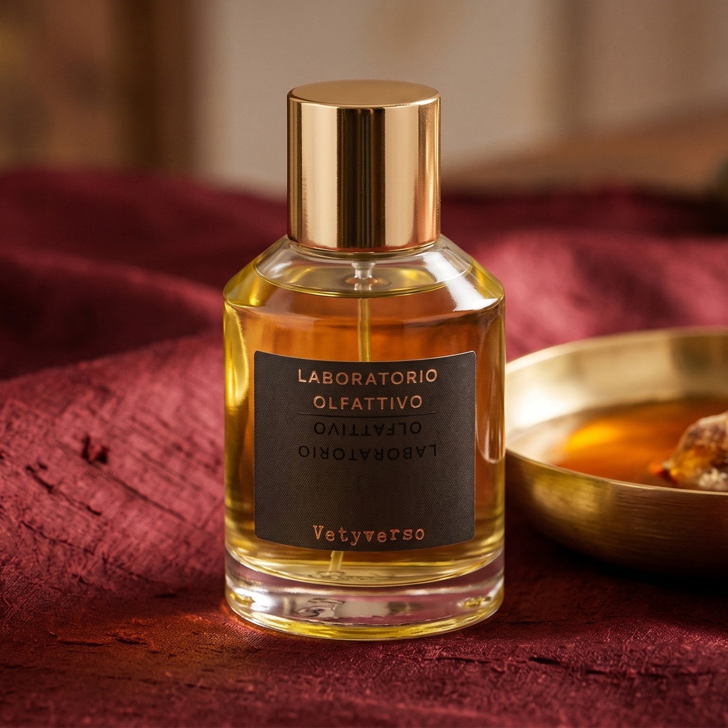 Laboratorio Olfattivo Vetyverso EDP on russet silk with a matte brass bowl holding tonka and amber pieces