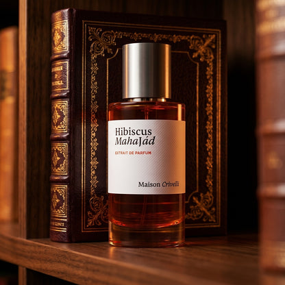 Maison Crivelli Hibiscus Mahajad EDP on tanned leather desk blotter beside a brass letter opener