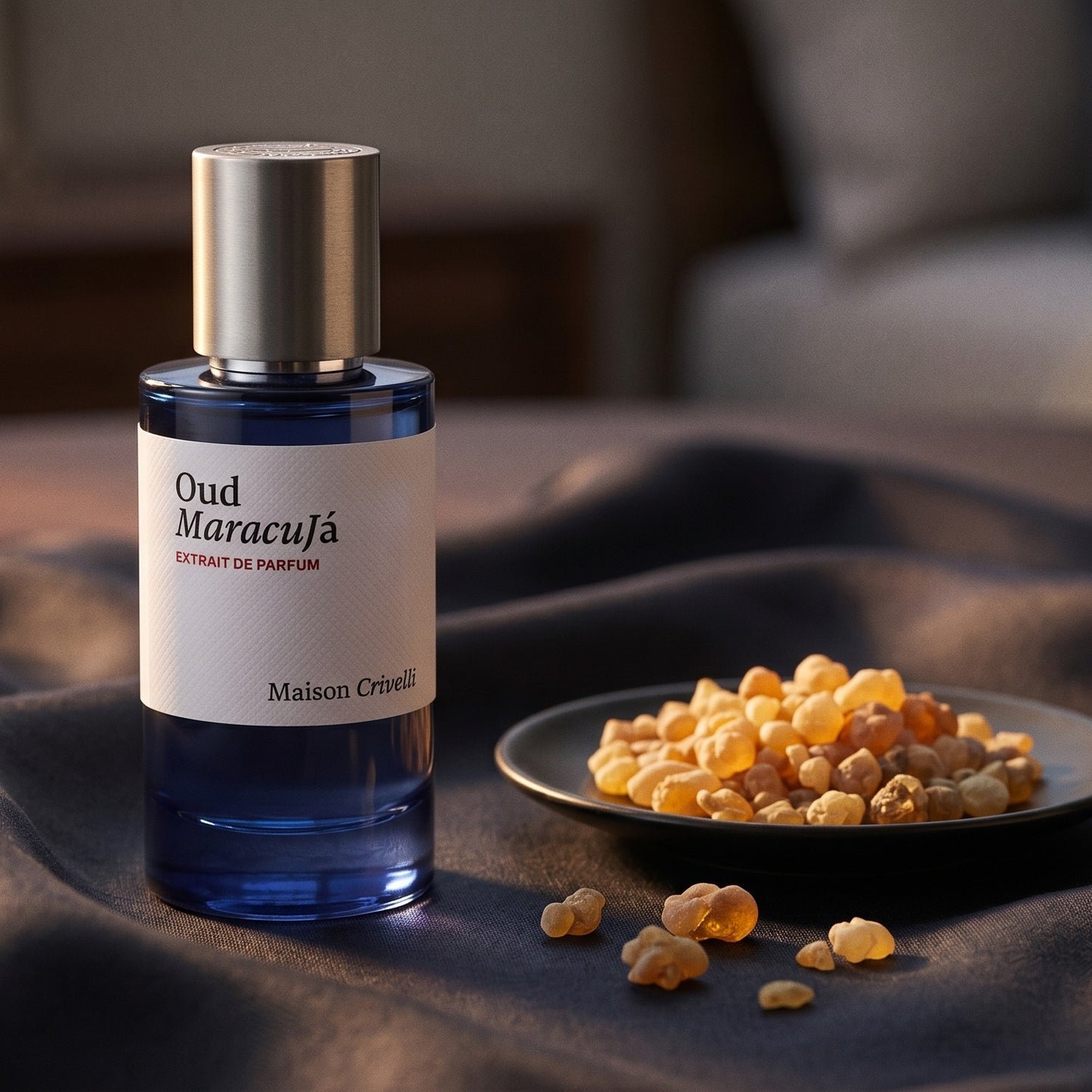 Maison Crivelli Oud Maracuja on burnt-orange silk with smoldering agarwood on a stone dish