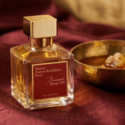 Maison Francis Kurkdjian (MFK) Baccarat Rouge 540 on raw silk of oxblood color with a brass bowl of ambergris tincture