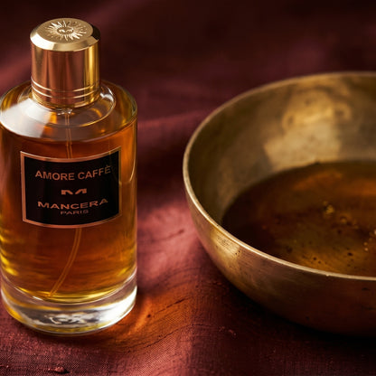 Mancera Amore Caffe on burnt-orange raw silk with a brass vial of frankincense oil