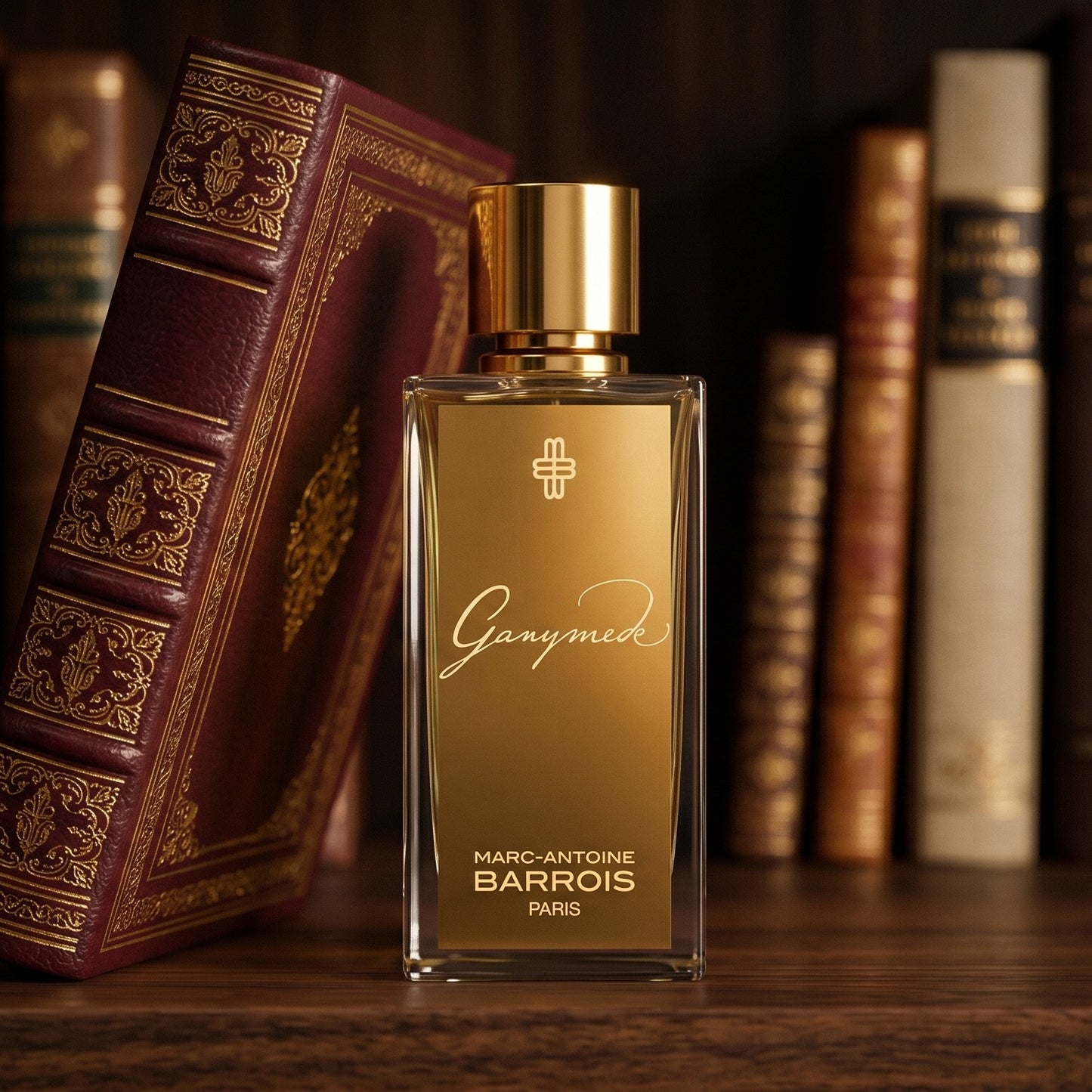 Marc-Antoine Barrois Ganymede EDP on deep burgundy leather journal spread beside a crystal inkwell