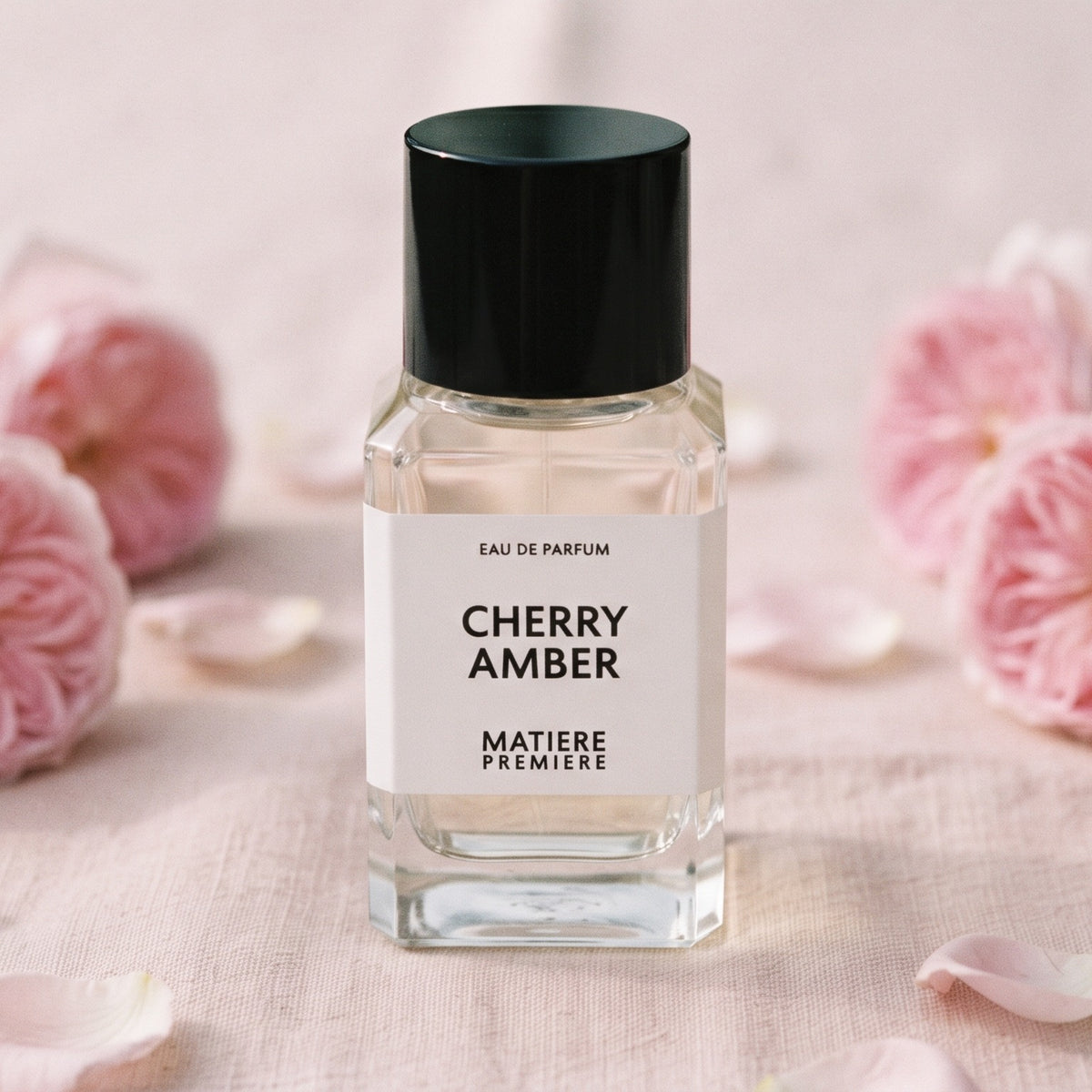Matiere Premiere Cherry Amber EDP on pale blush linen with centifolia roses