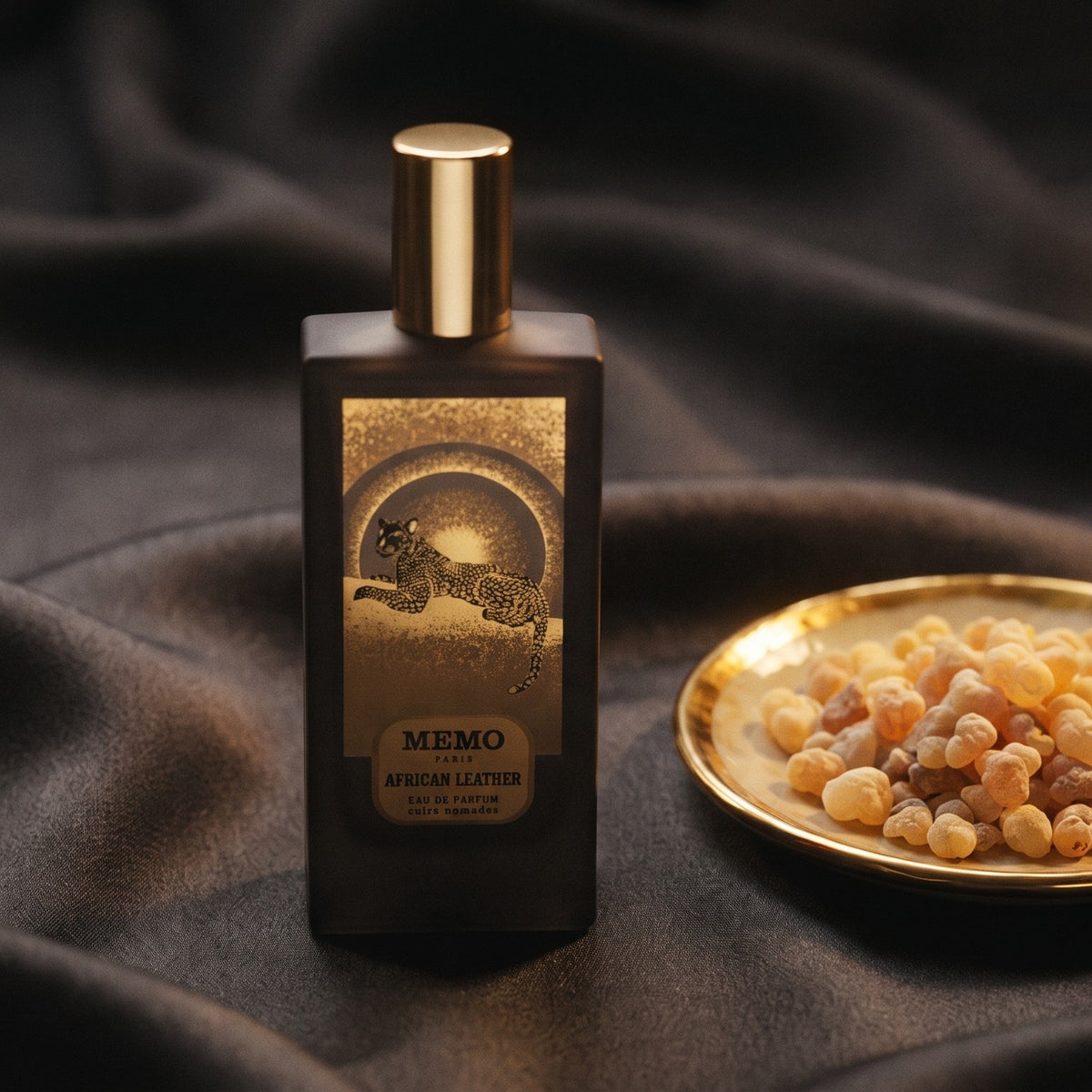 Memo Paris African Leather EDP on charcoal silk with frankincense resin granules in a small saucer