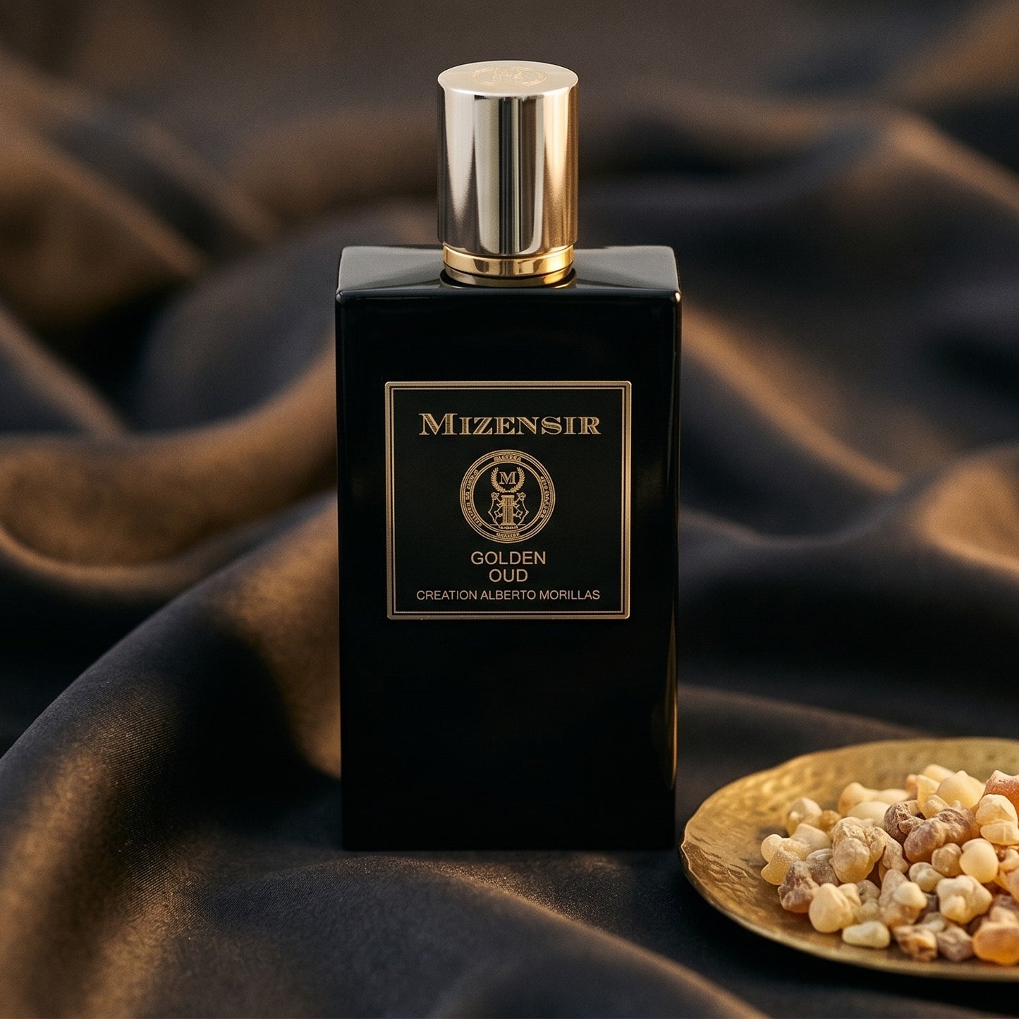 Mizensir Golden Oud EDP on black velvet with a thread of smoking oud between folds