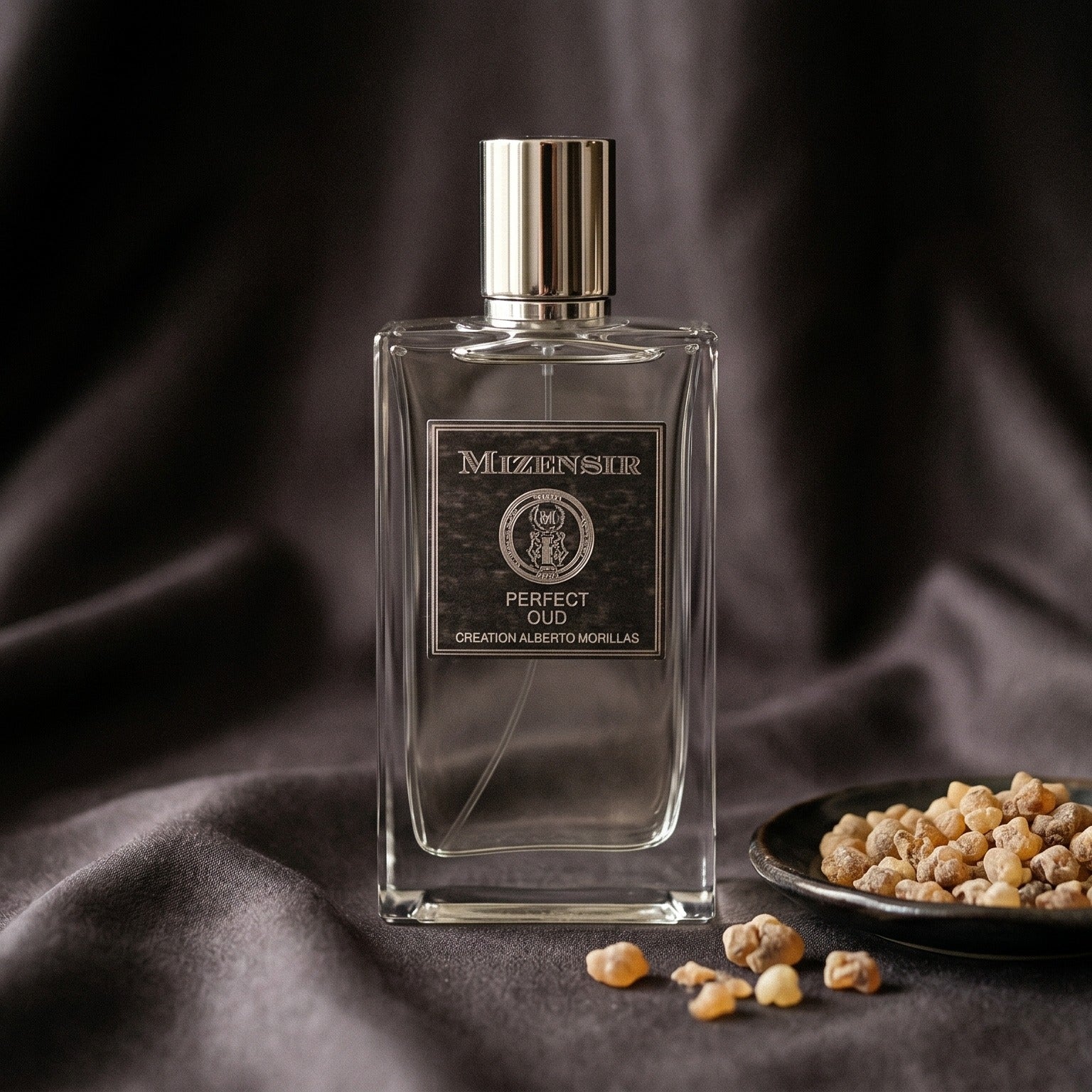 Mizensir Perfect Oud EDP on burnt-orange silk with smoldering agarwood on a stone dish