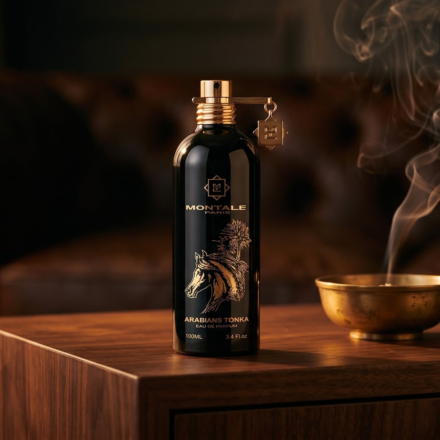 Montale Arabians Tonka on smoked-glass tabletop with a lacquered incense burner in mid-glow