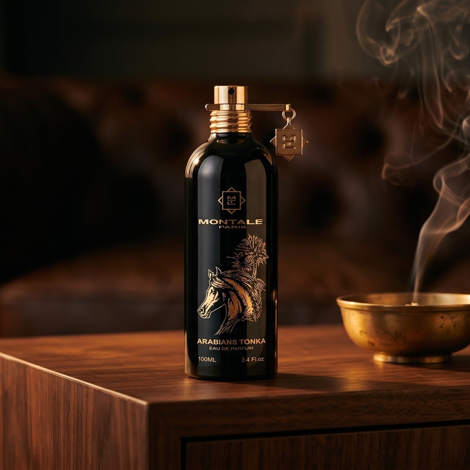 Montale Arabians Tonka on smoked-glass tabletop with a lacquered incense burner in mid-glow