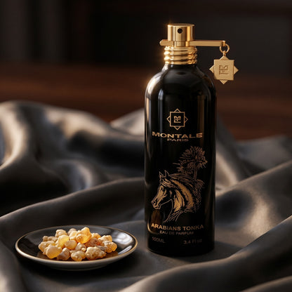 Montale Arabians Tonka on burnt-orange silk with smoldering agarwood on a stone dish