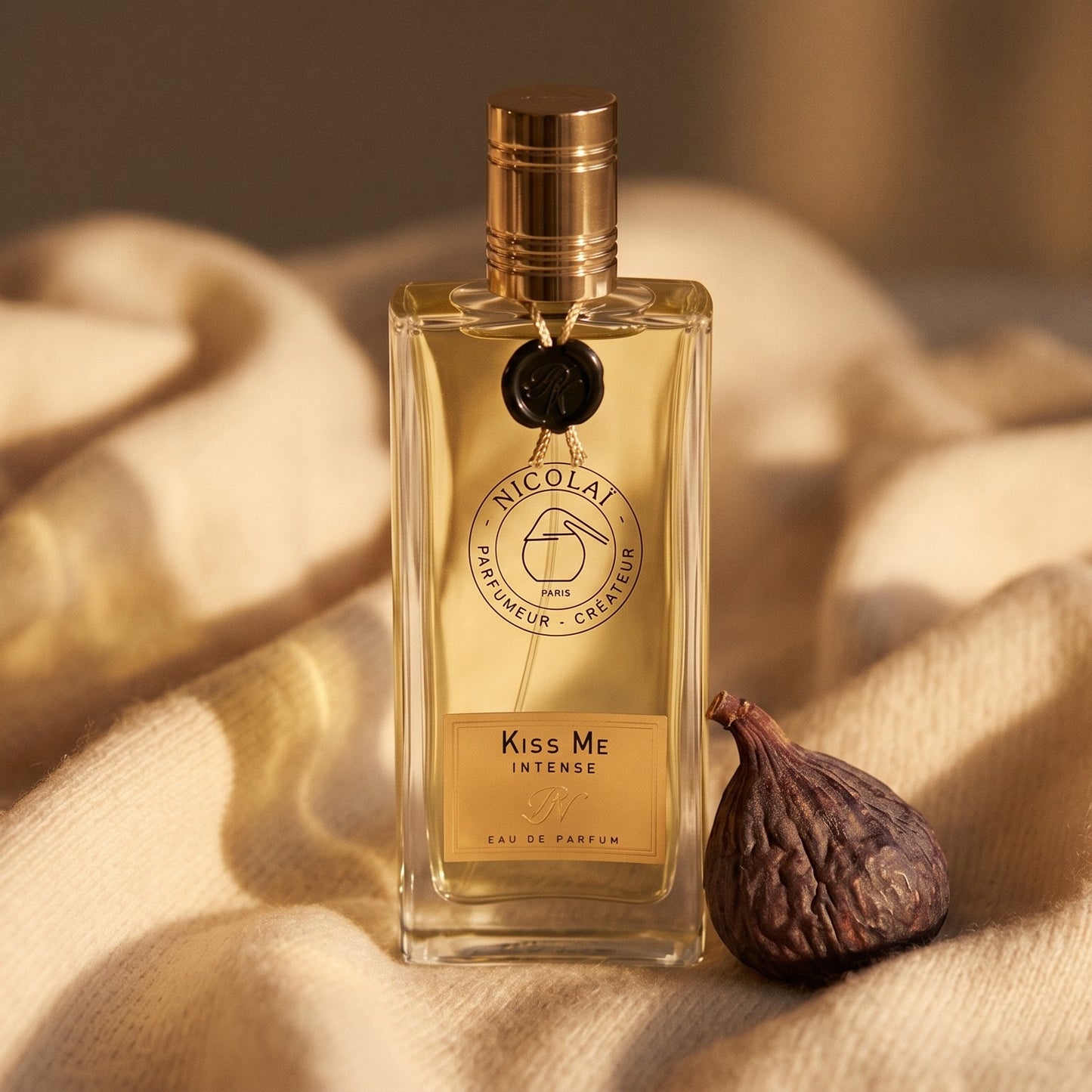 Nicolai Kiss Me Intense EDP on sand-colored mohair with a dried apricot split in two