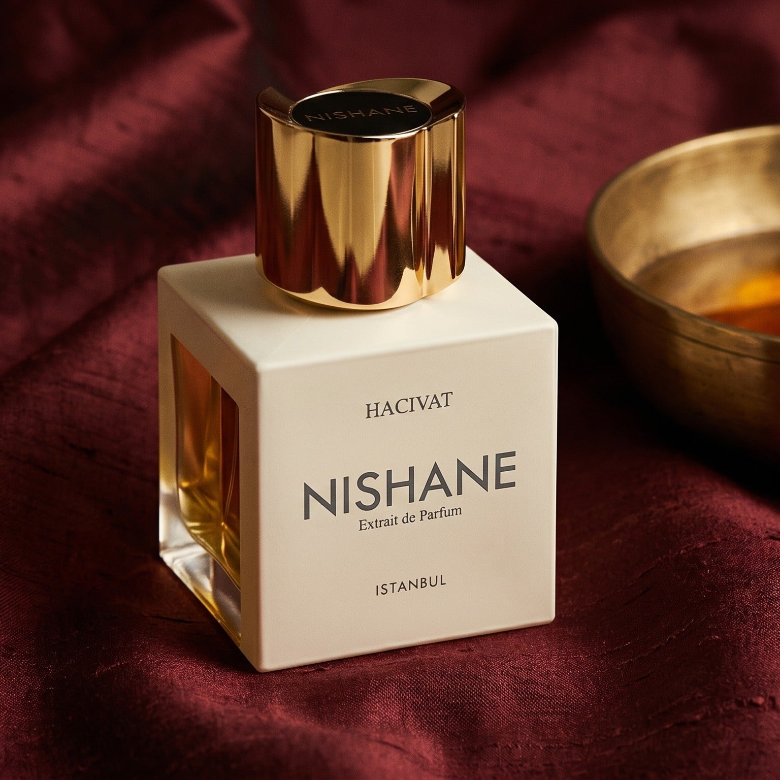 Nishane Hacivat Extrait De Parfum on deep caramel velvet with a small copper jar of resin balm