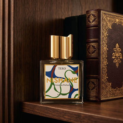 Nishane Tero EDP on tanned leather desk blotter beside a brass letter opener
