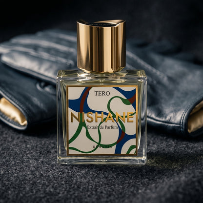 Nishane Tero EDP on black suede surface with a folded pocket square beside the base