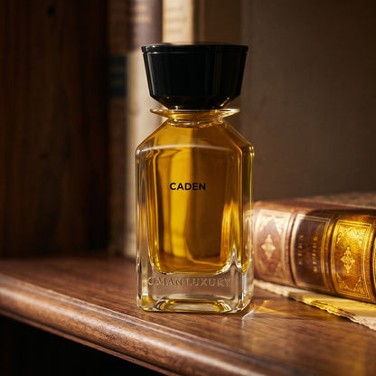 Oman Luxury Caden EDP on tanned leather desk blotter beside a brass letter opener
