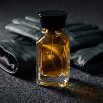 Oman Luxury Caden EDP on black suede surface with a folded pocket square beside the base