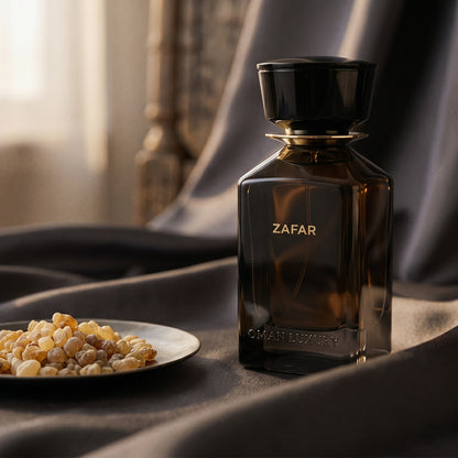 Oman Luxury Zafar EDP on deep indigo silk with a tiny copper bowl of myrrh pellets
