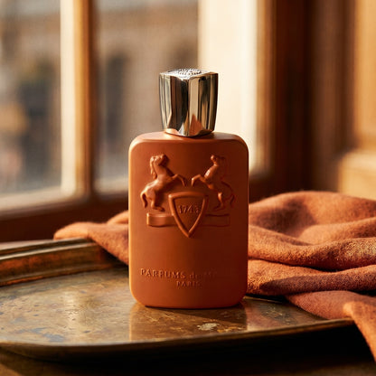 Parfums de Marly Althair EDP on aged brass tray with a folded pashmina in rust tone