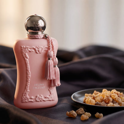 Parfums de Marly Delina Exclusif Parfum on charcoal silk with frankincense resin granules in a small saucer